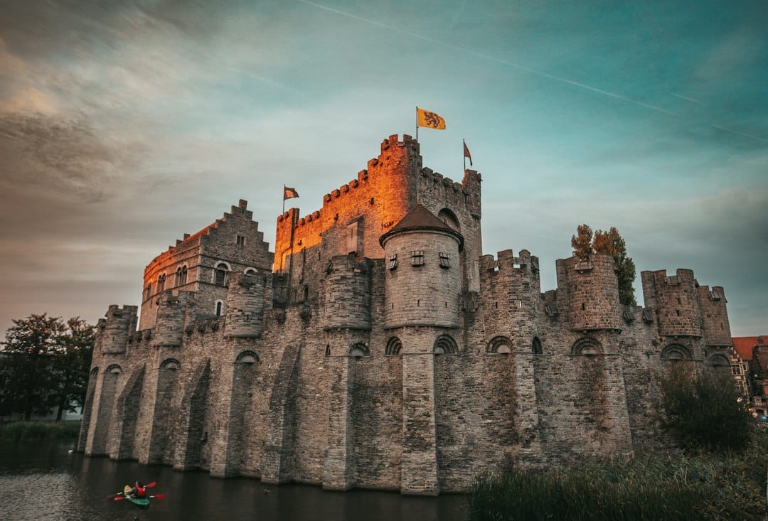 The medieval stone fortress of Gravensteen with its moat in Ghent