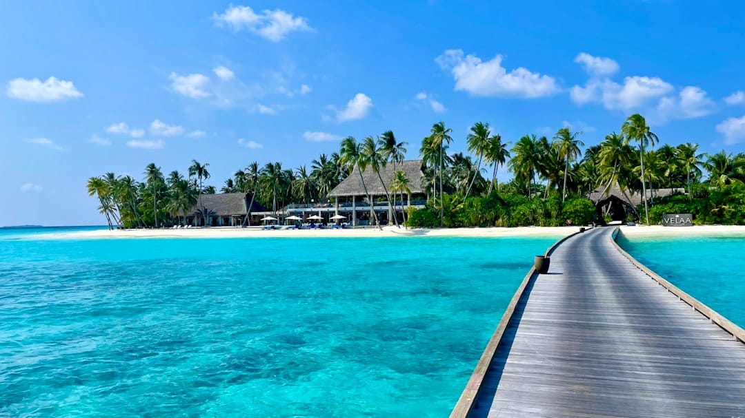 Overwater villas on stilts above a turquoise Maldives lagoon