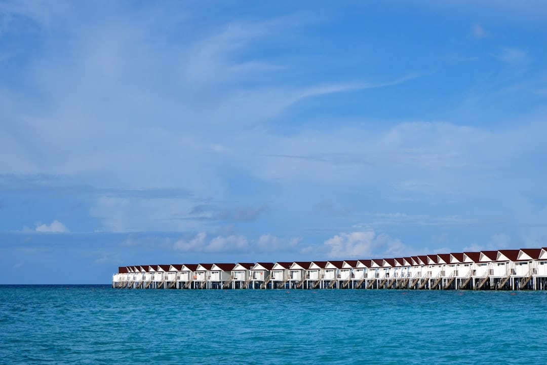 Overwater villas on stilts above a turquoise Maldives lagoon