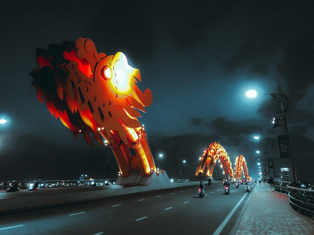 The Dragon Bridge lit red and yellow over the Han River at night