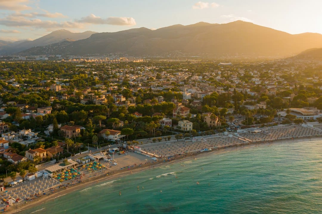 The turquoise water and white sand crescent of Mondello beach near Palermo