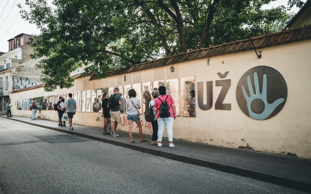 A street wall in the Uzupis district of Vilnius with the UZ symbol and open-air photo gallery