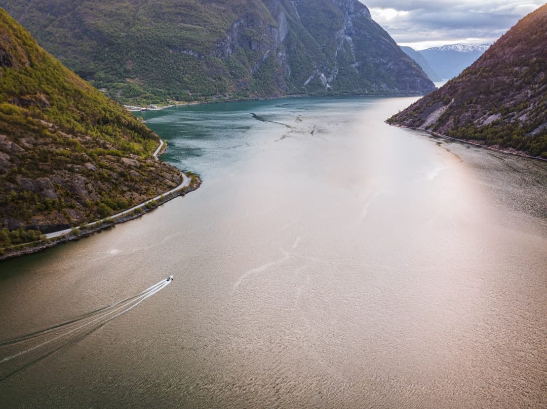 A narrow Norwegian fjord with steep green sides