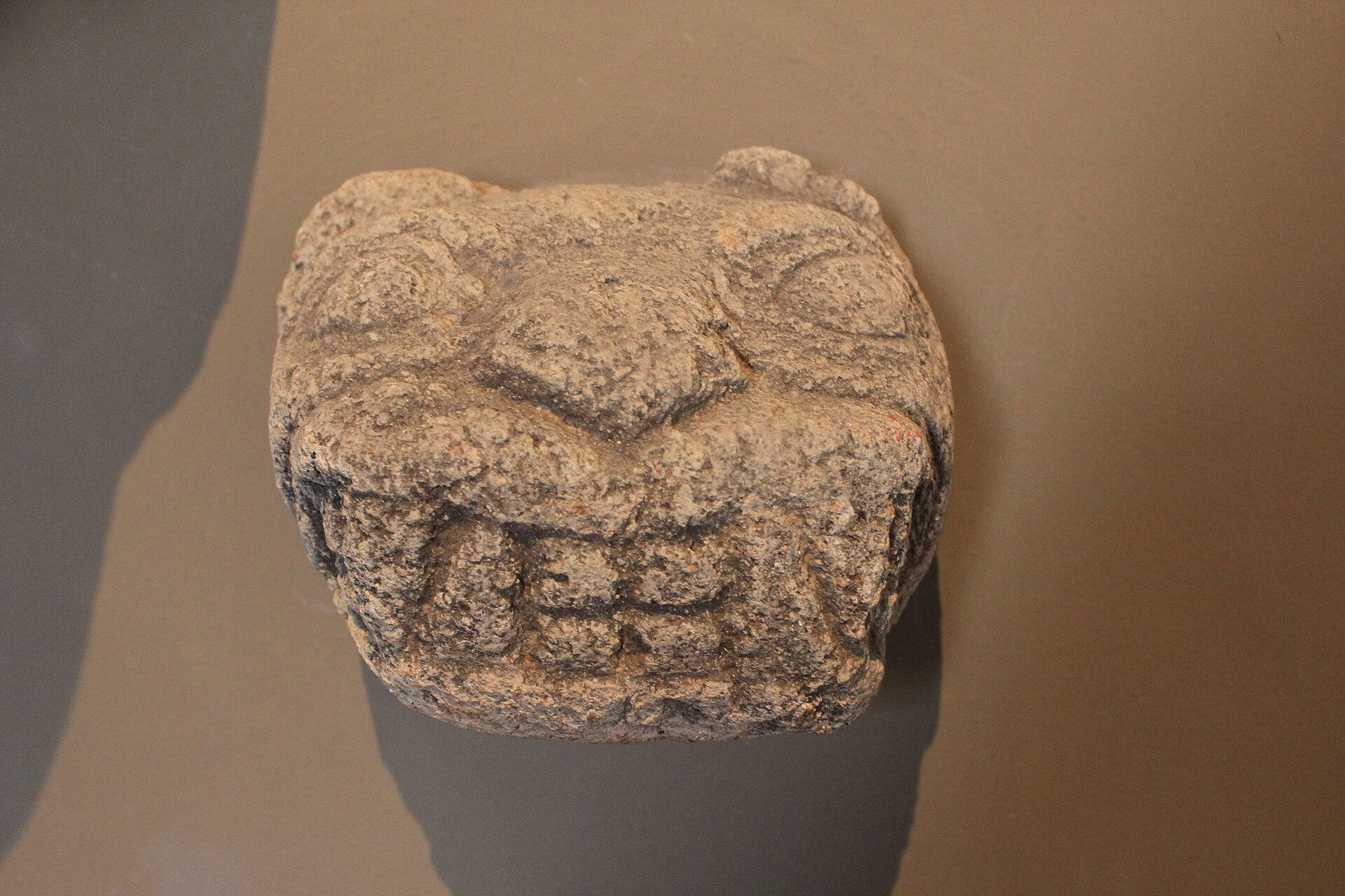A carved stone feline deity head from the Museo Larco pre-Columbian collection in Lima