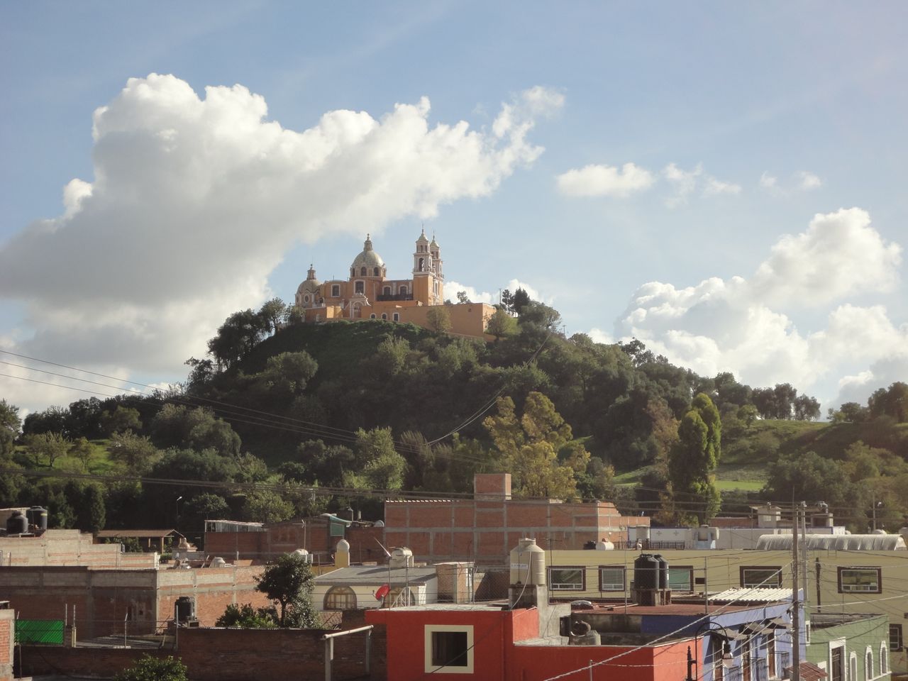 The yellow Santuario de los Remedios church atop the grassed-over Great Pyramid of Cholula