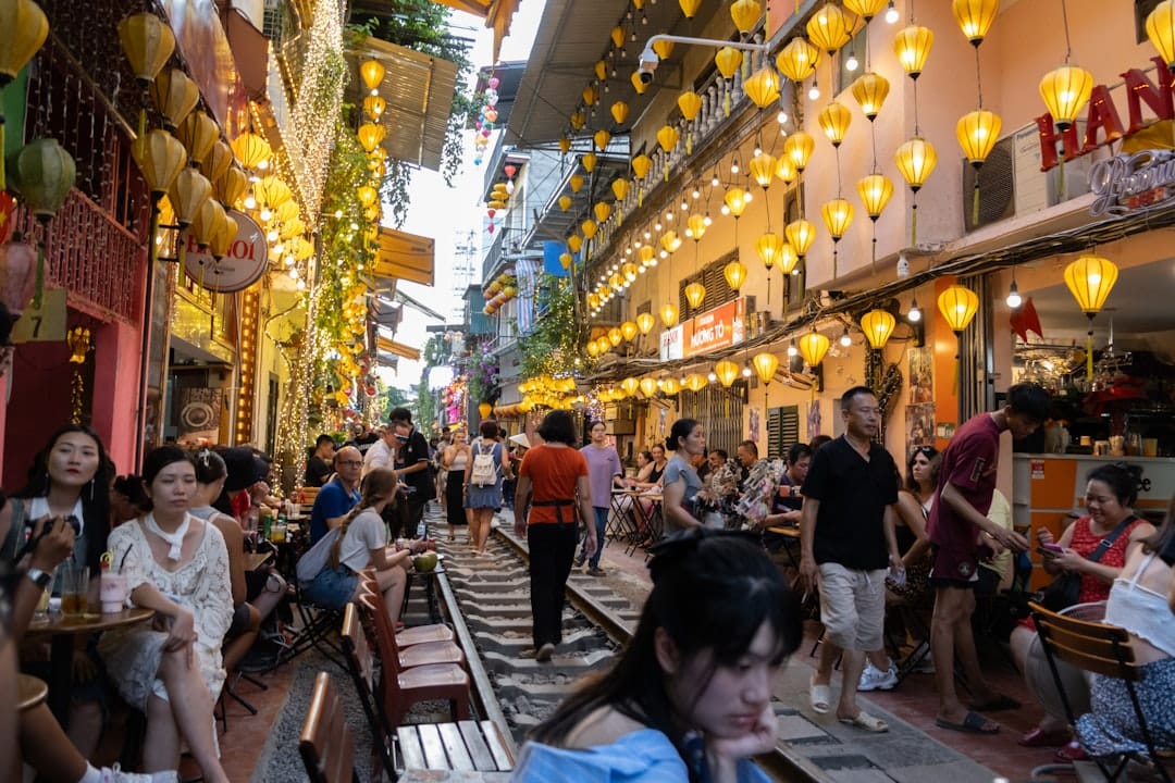People walking along Hanoi's Train Street in the Old Quarter
