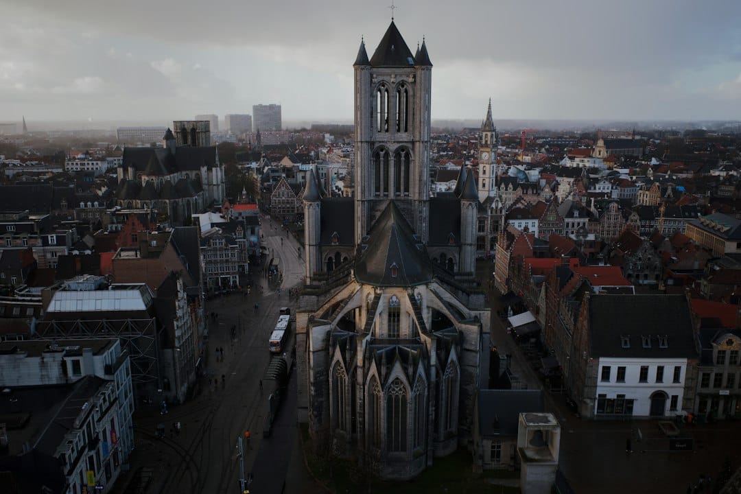 The grey stone facade of St Nicholas' Church in central Ghent