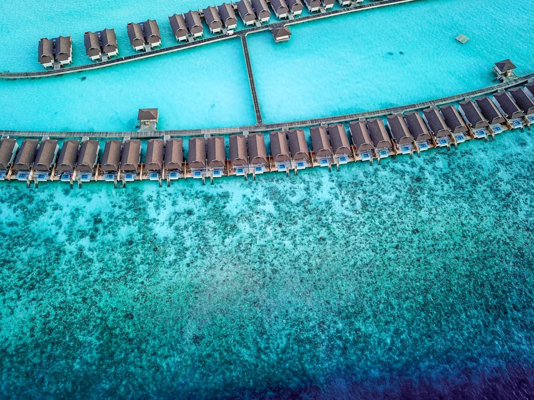 Overwater villas on stilts above a turquoise Maldives lagoon