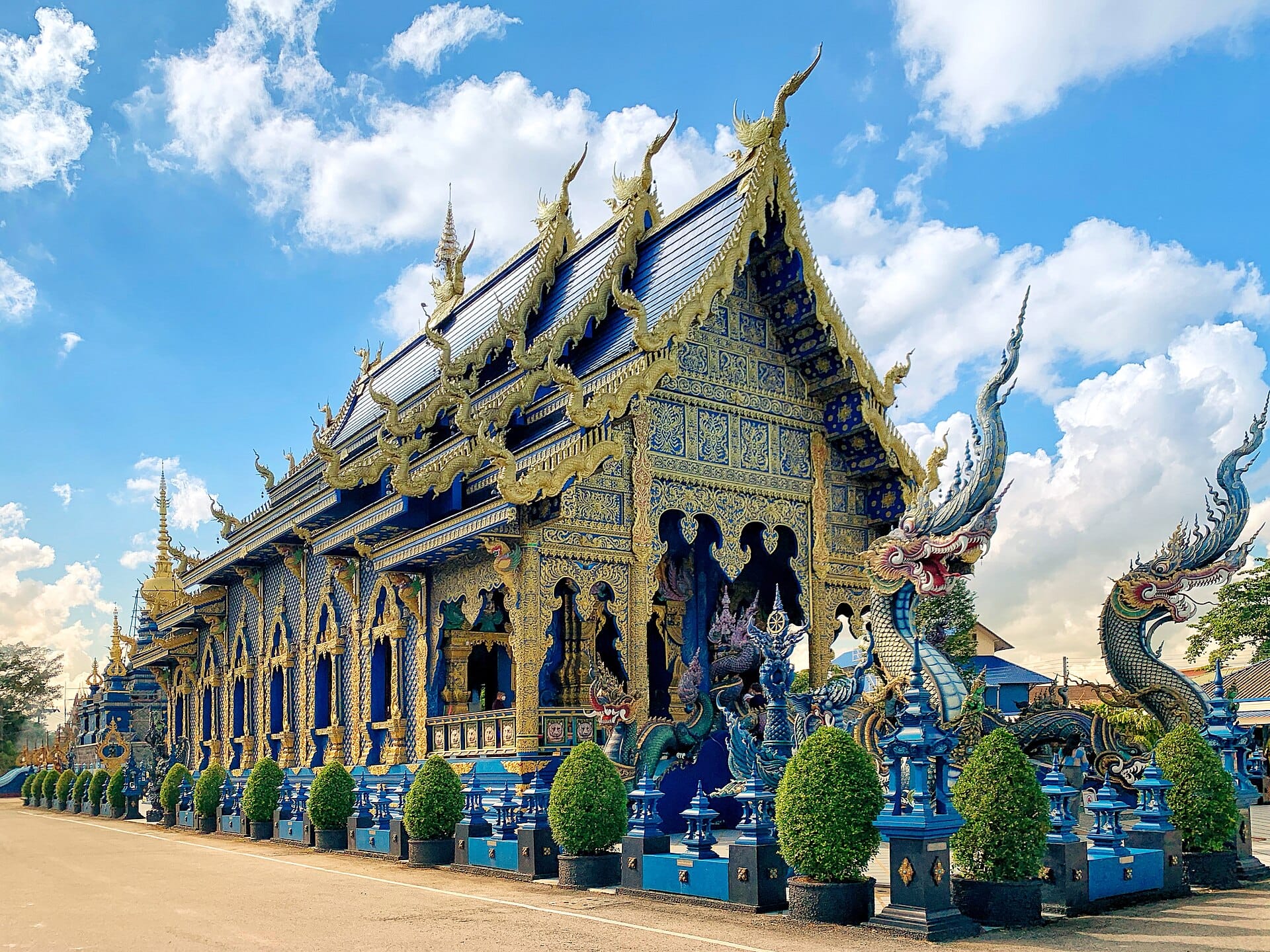 The cobalt-blue and gold Wat Rong Suea Ten (Blue Temple) with naga guardians, Chiang Rai