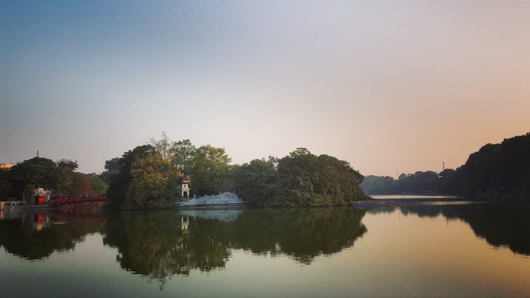 Hoan Kiem Lake in Hanoi with trees reflected in still water